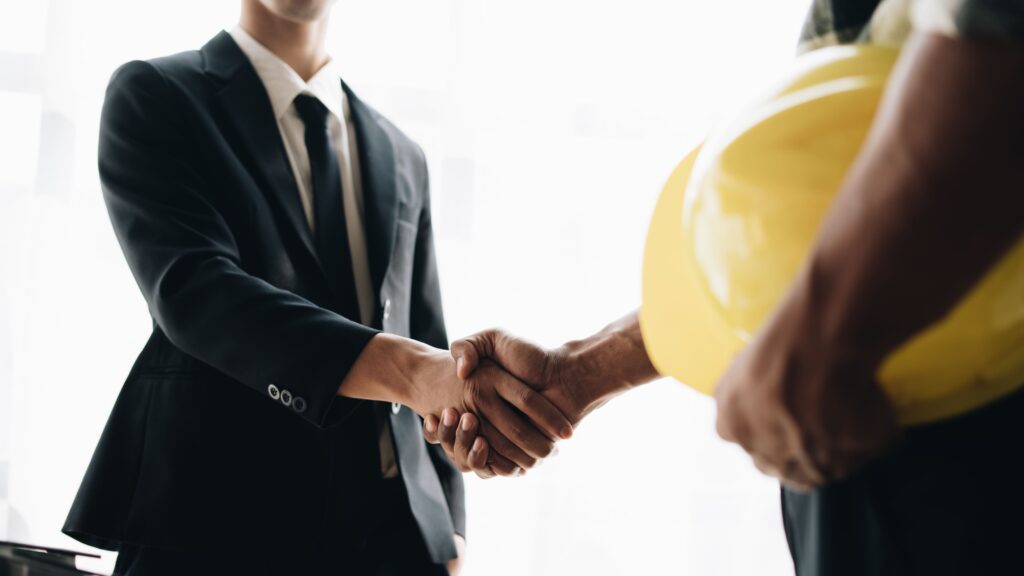 Foundation Stabilization Contractors in New York - A Contractor and a Business Owner Shaking Hands