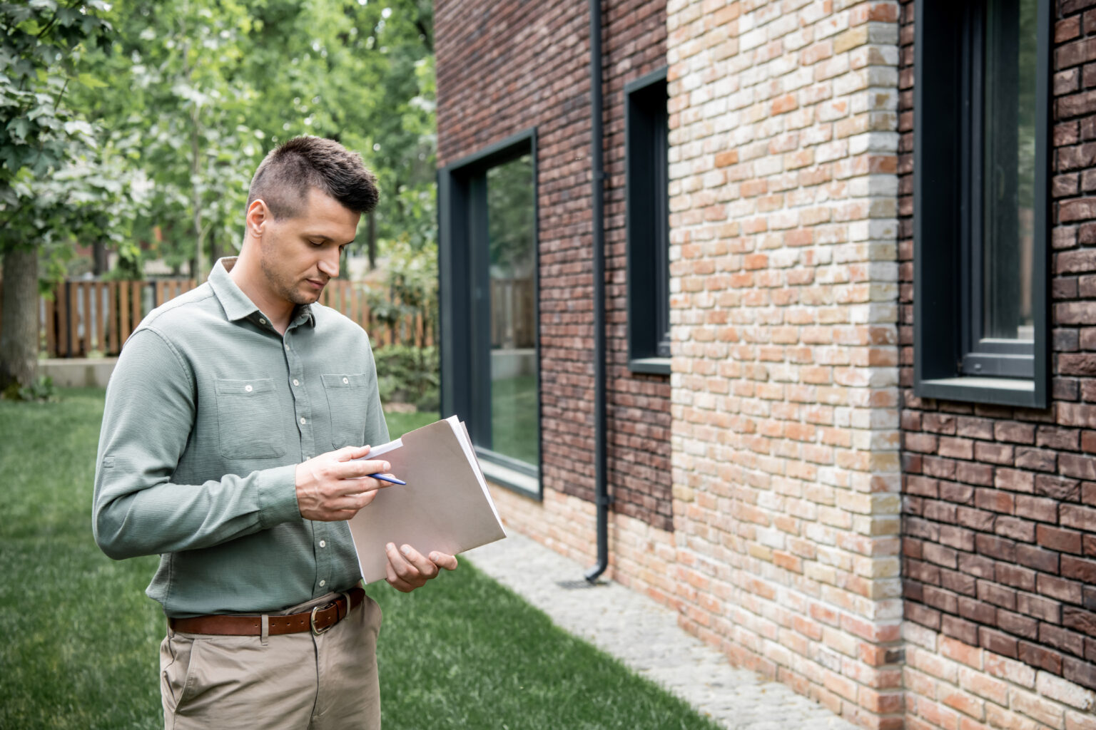 Free Foundation Inspections - A Foundation Inspector Looking at His Booklet