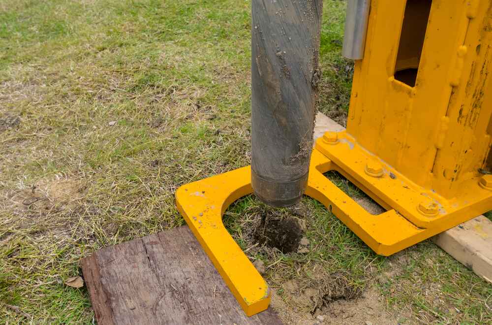 Helical Piers for New Construction - A Soil Auger Drill Taking a Soil Sample