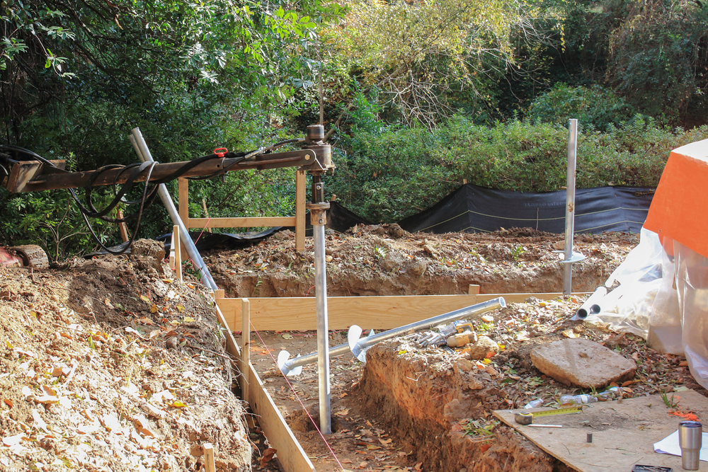 What Are Helical Piers? A Helical Pier Being Driven Into the Ground for a Foundation