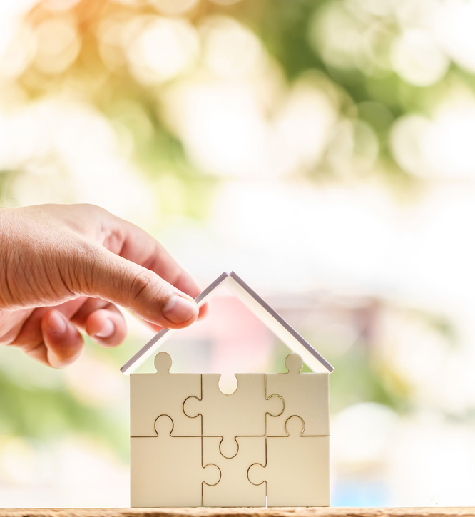 Helical Piers for Docks - A Man Placing a Roof Over a Small House Model with Sunny Day Background