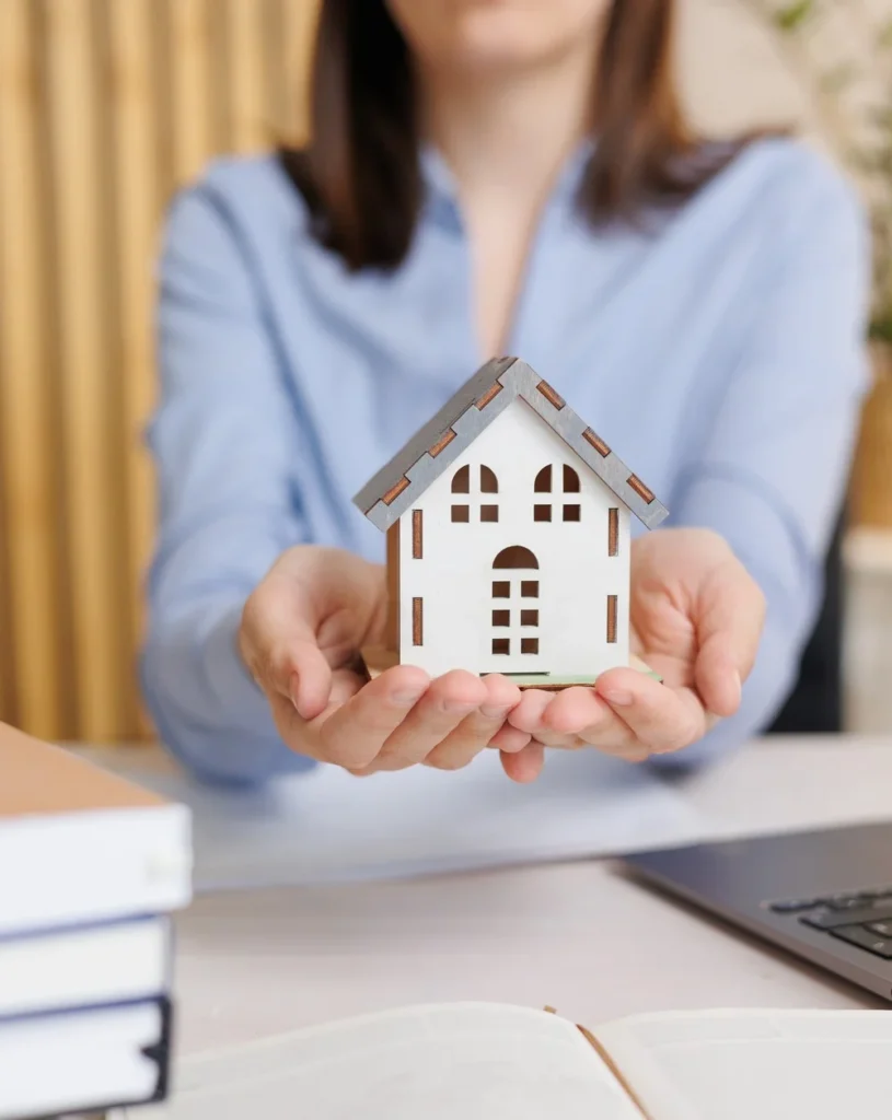 Crawl Space Support - A Woman Holding a Small House Model in Her Hands to Symbolize Protection