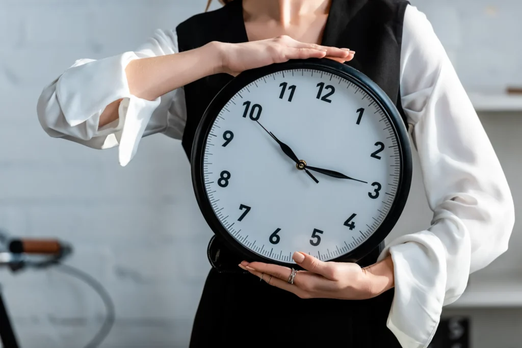 Mechanically Stabilized Earth Wall Services for Long Island, Brooklyn, and Queens, NY - A Woman Holding a Clock