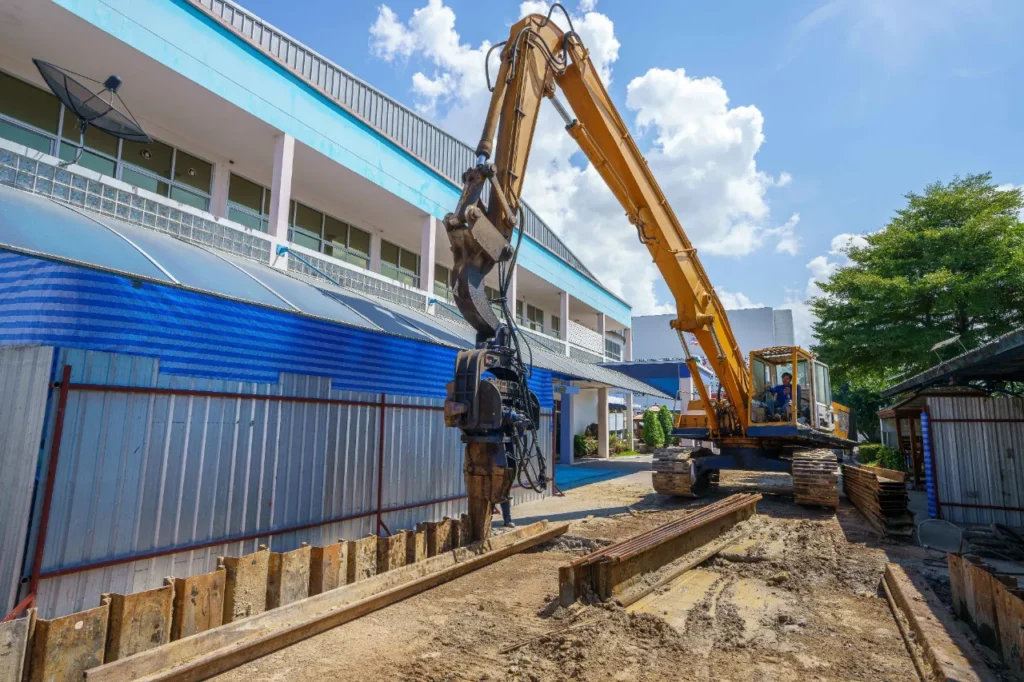 Steel Sheet Pile Contractors in New York - A Tractor Installing Steel Sheet Piles