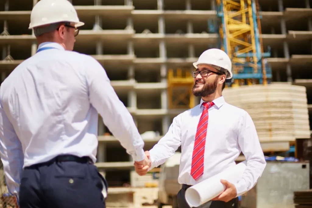 What Can You Claim on Taxes for Home Improvements - Two Contractors Shaking Hands at a Commercial Site