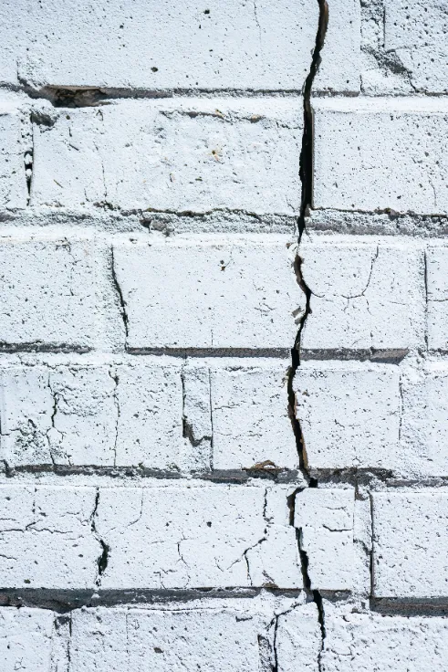 Can You Replace a Foundation Without Lifting the House - A Vertical Foundation Crack in a White Brick Foundation Wall