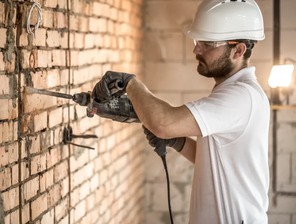 Foundation Wall Brace - A Construction Worker Working On a Wall