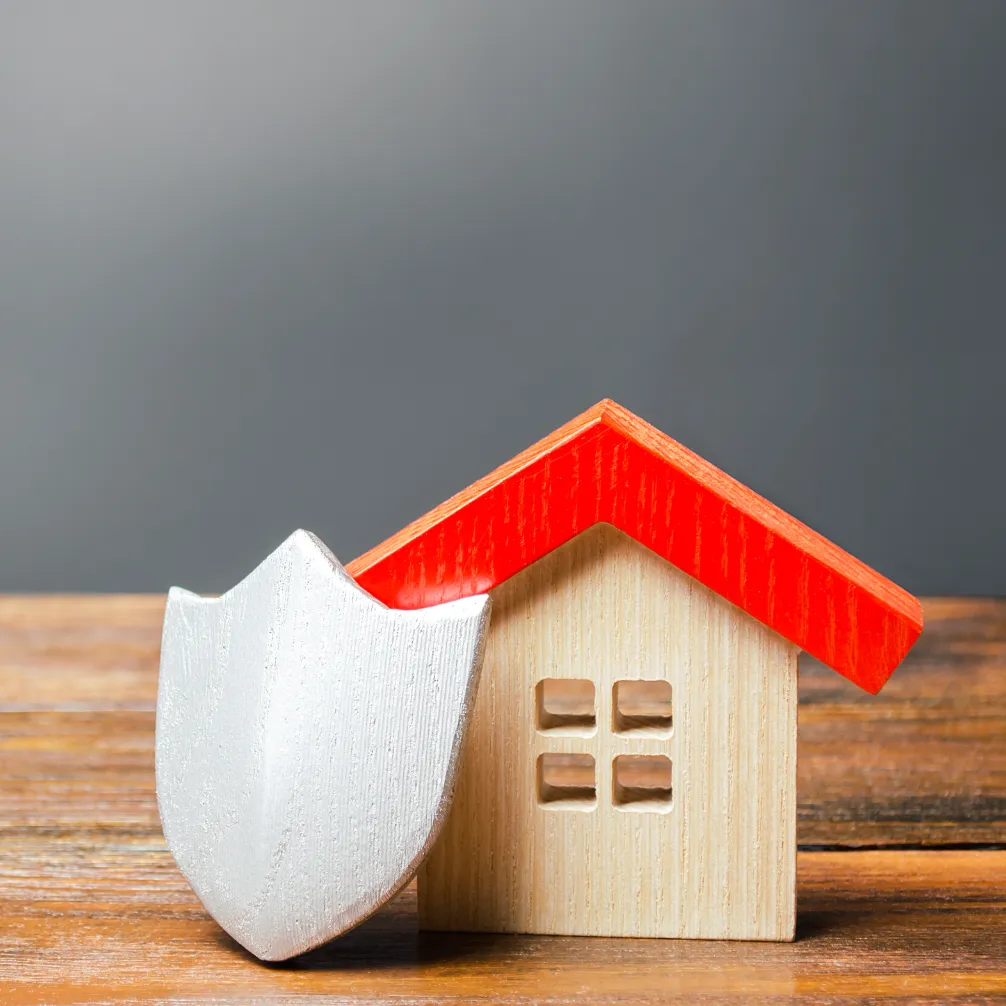 Helical Ground Anchors - A Small House Model with a Shield in Front of it on a Table