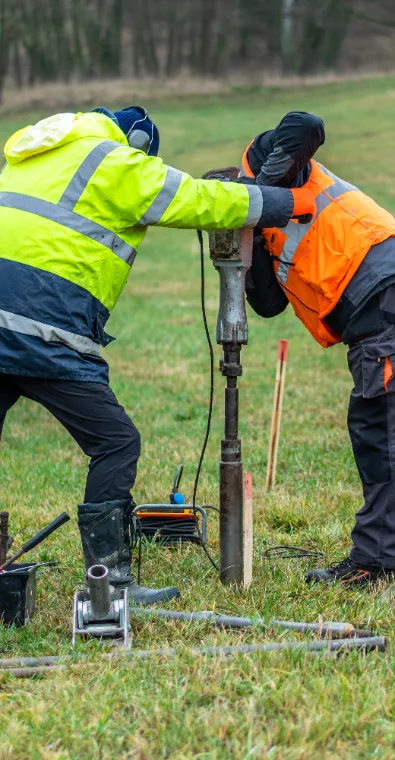 Long Island Soil Types - A Picture of Two Construction Workers Taking a Soil Sample