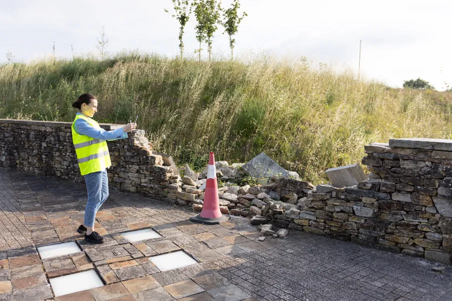 How Long Do Retaining Walls Last? An Inspector Taking Pictures of a Failed Retaining Wall